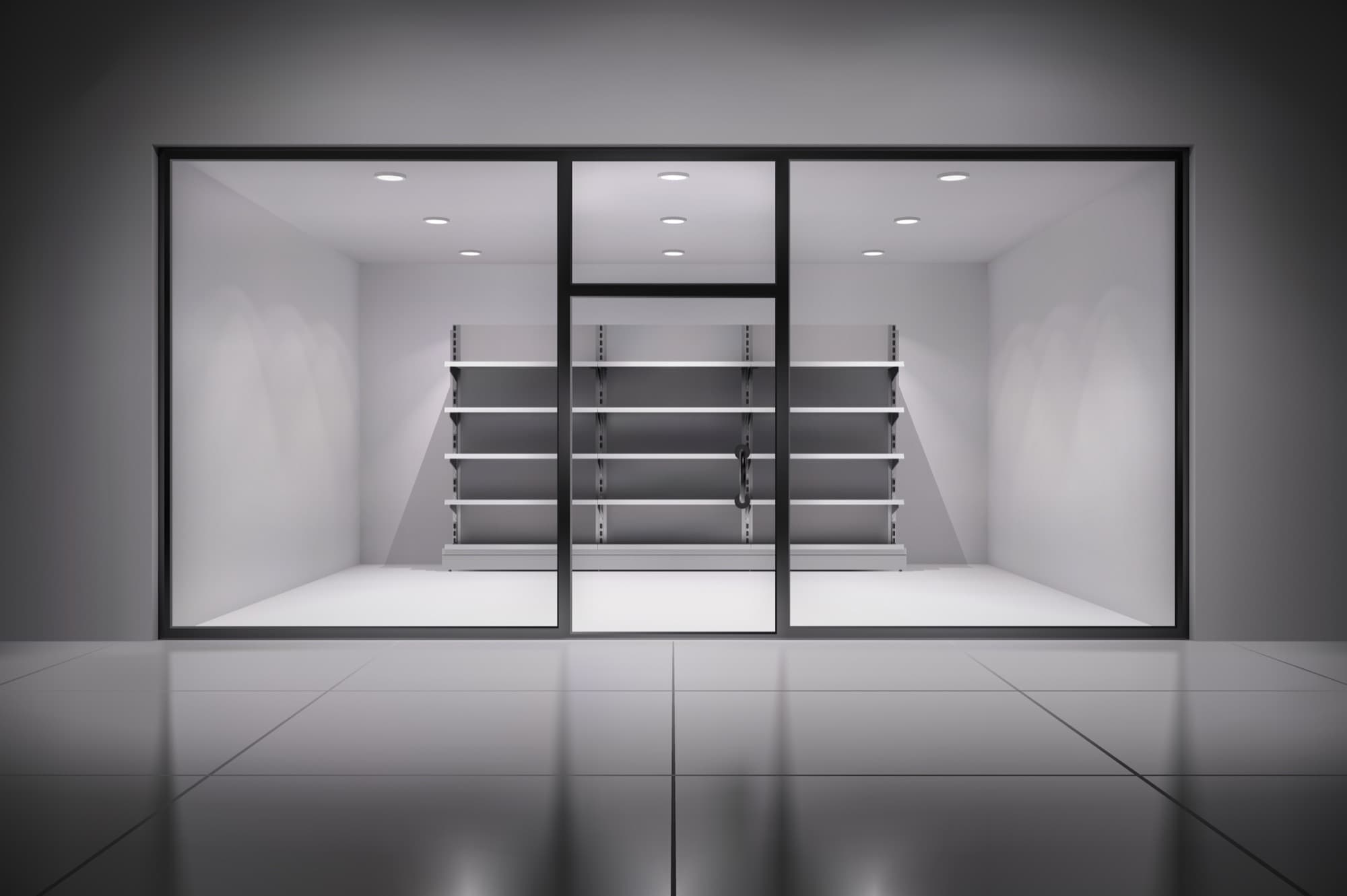 Glass curtain-wall facade with a central sliding door in a bright, minimal interior.